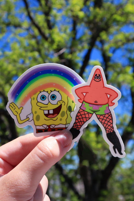 spongebob imagination sticker and patrick in heels sticker held up in front of blurred out background outside