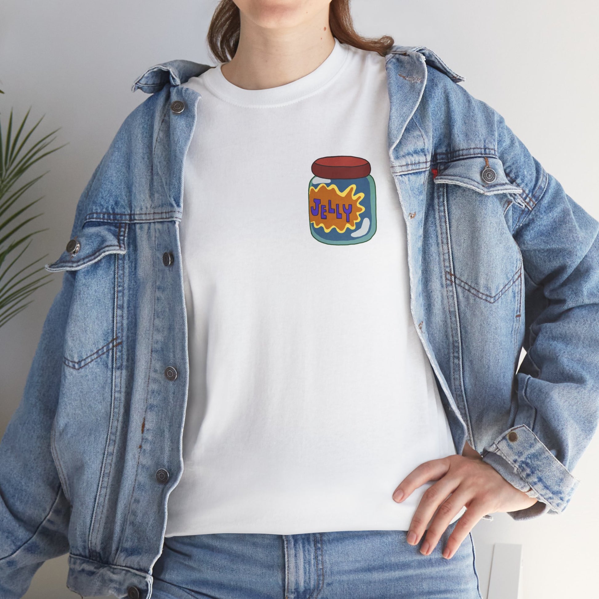 upclose shot of a girl wearing a denim jacket with a white tshirt underneath. the white tshirt has a colorful jelly jear logo on its left pocket area.