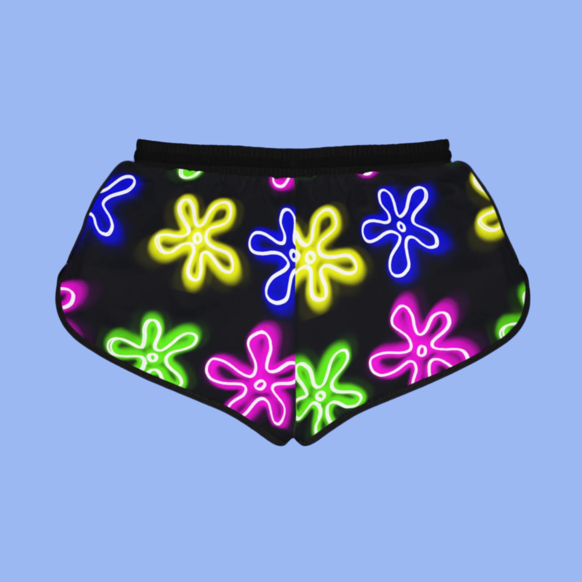back view of women's shorts with black trim and black material featuring a neon flower pattern