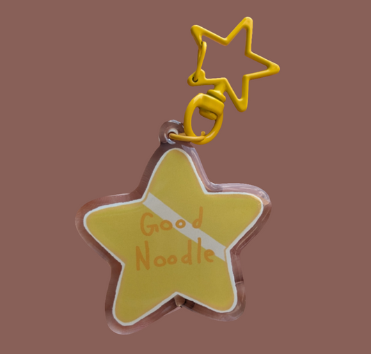 yellow star keychain on brown background with star shaped yellow key ring to match