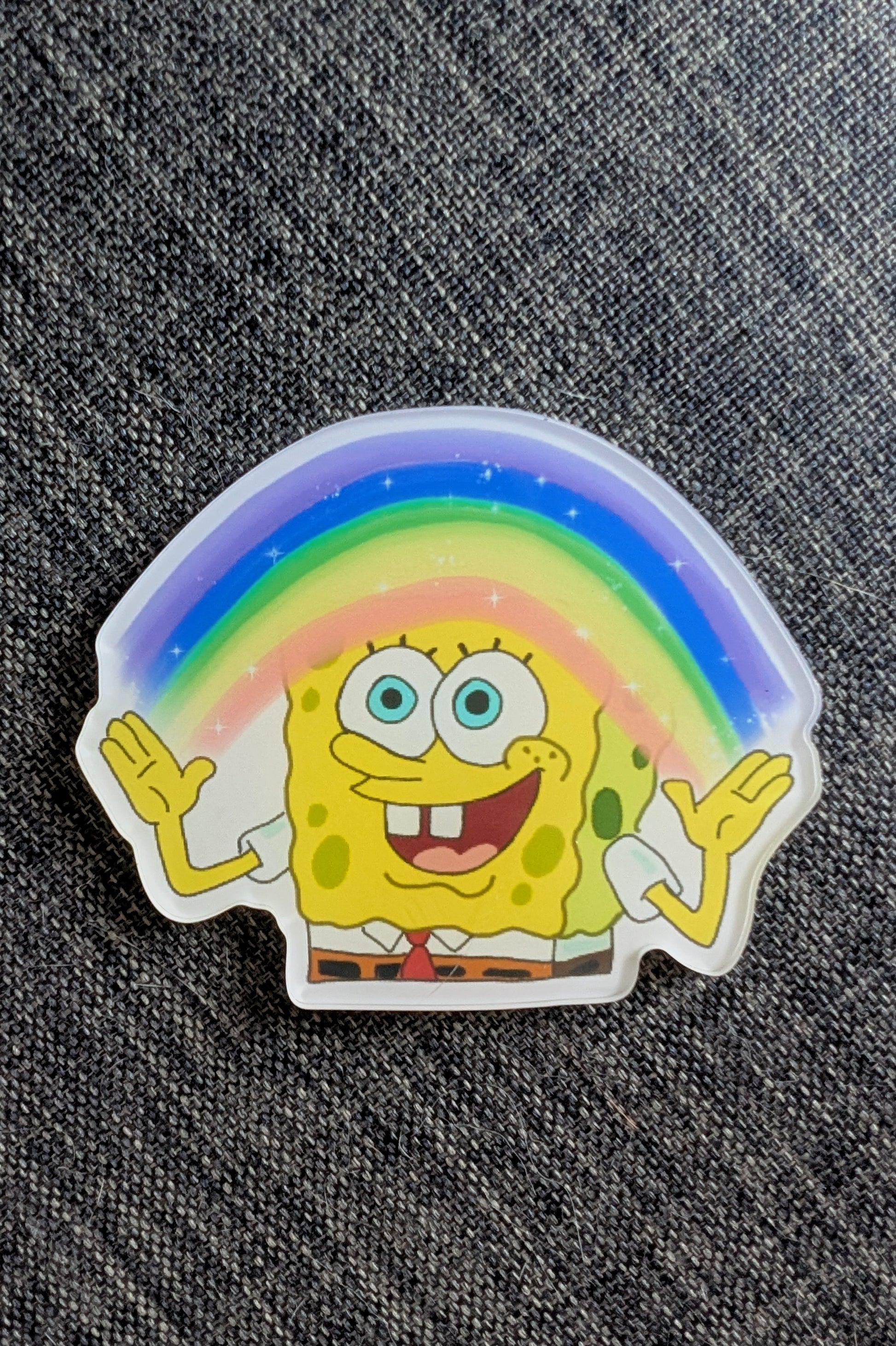 spongebob squarepants holding a rainbow in his hands smooth magnet