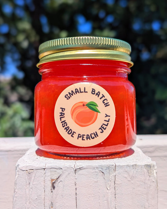 jar of palisade peach jelly with a circle label featuring an illustrated peach by jellyfishparty