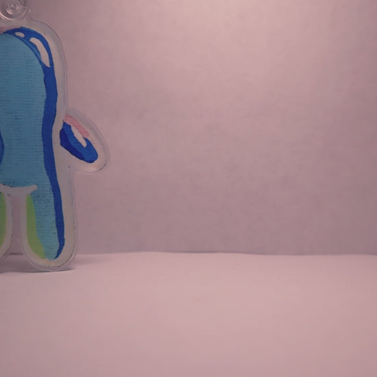 stop motion video of a bubble buddy keychain walking across a white room