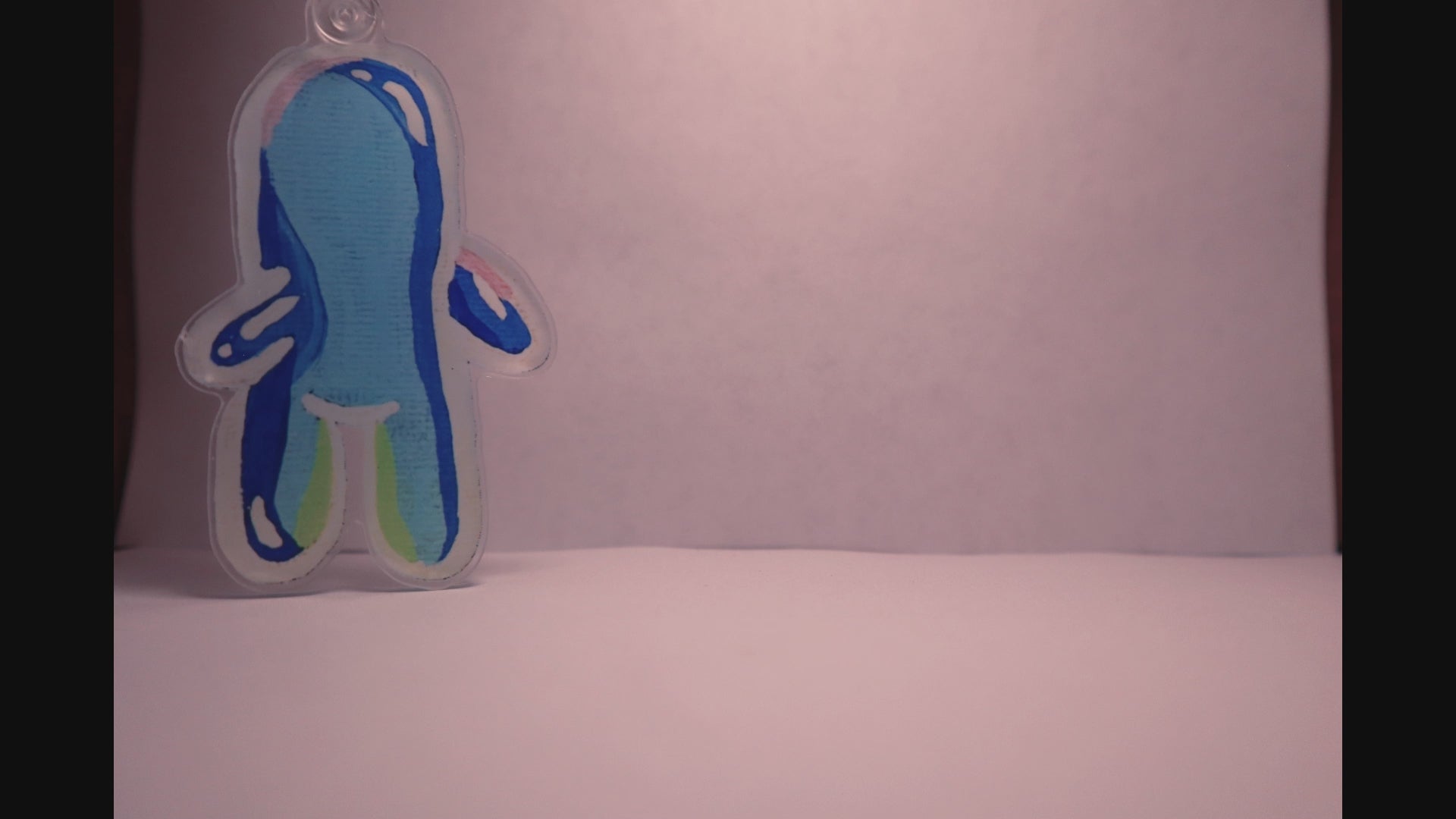 stop motion video of a bubble buddy keychain walking across a white room