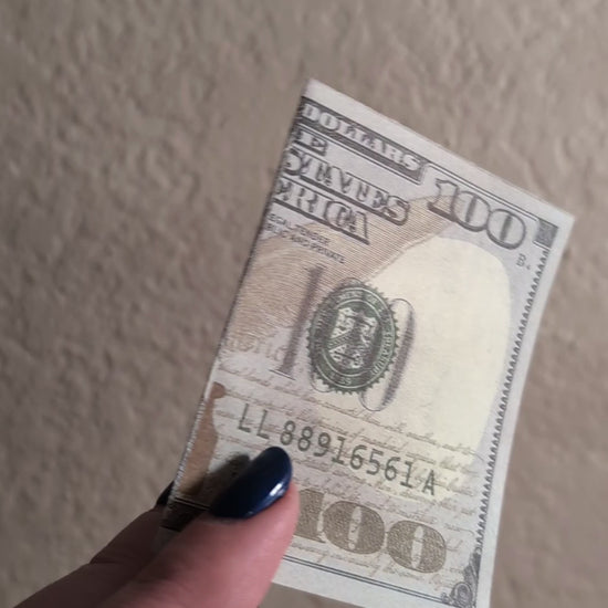 sped up dollar bill opening with smiley face inside