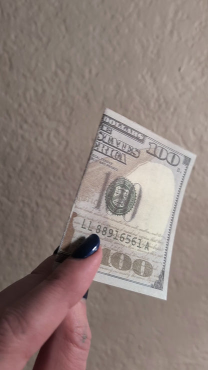 sped up dollar bill opening with smiley face inside