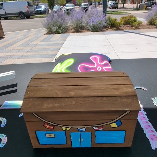 a four second video of a mini krusty krab treasure chest being opened and revealing spongebob themed stickers designed by jellyfishparty inside.