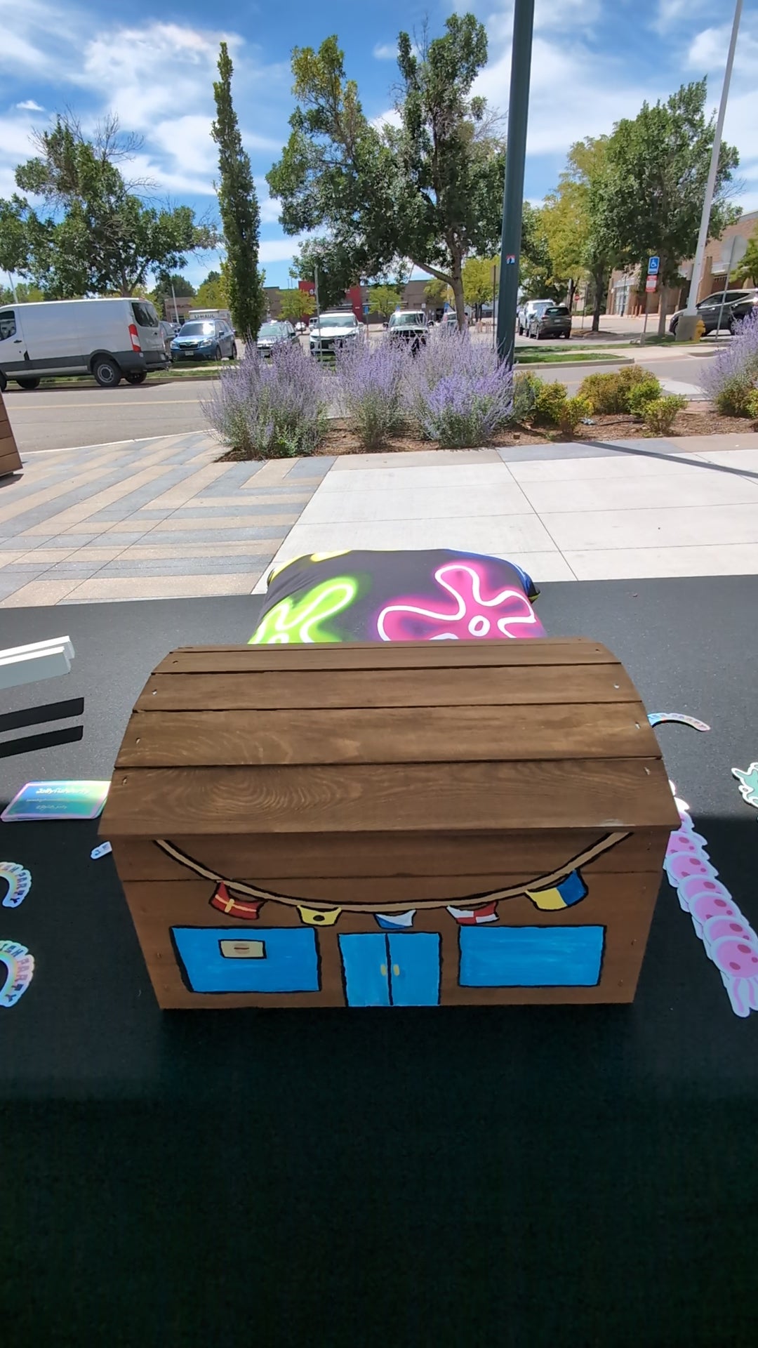 a four second video of a mini krusty krab treasure chest being opened and revealing spongebob themed stickers designed by jellyfishparty inside.
