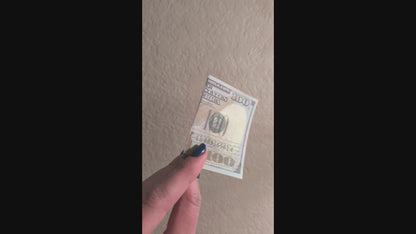 outside of one hundred dollar prank bill with smiley face inside