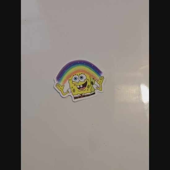 spongebob with rainbow imagination magnet thrown onto a glossy white magnetic surface