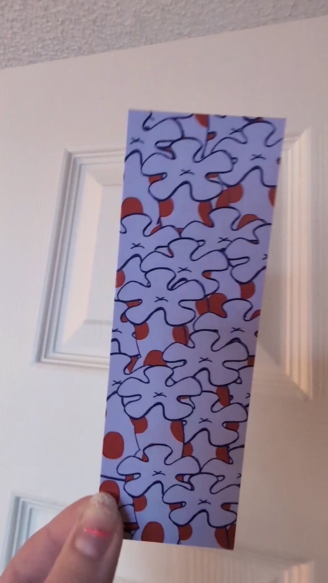 video showing both sides of purple spotted bookmark with corals