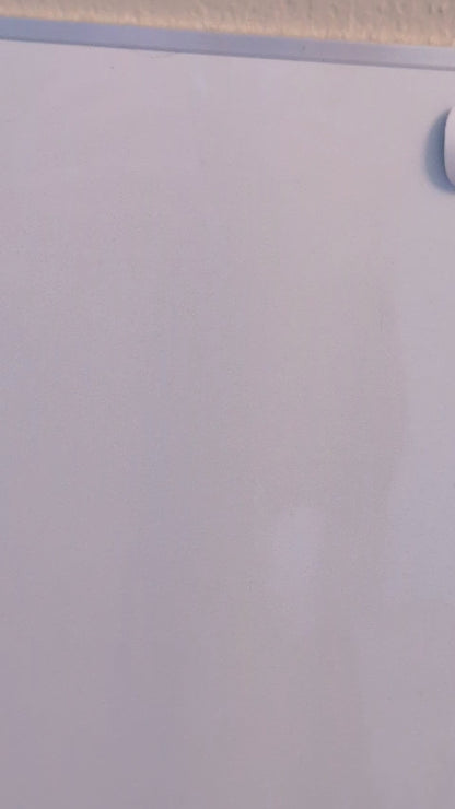 video of a bubble buddy painting magnet being thrown at a magnetic white board and sticking